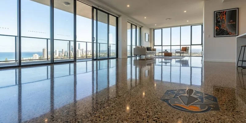 Mechanically polished concrete floor with deep reflective gloss showing aggregate pattern in a modern Gold Coast commercial space